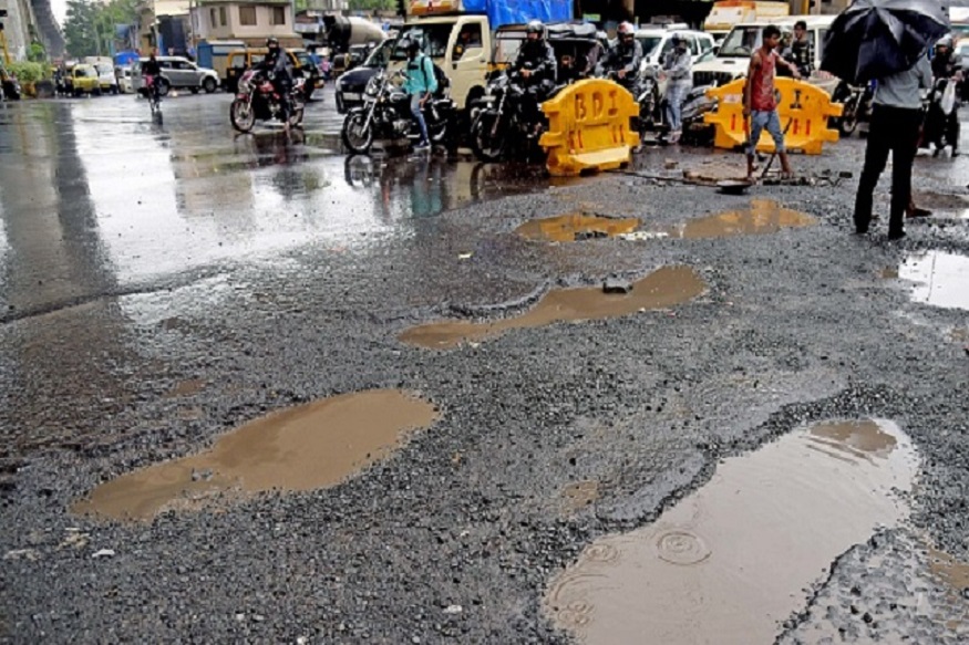 MUMBAI, INDIA - JULY 13: The recent heavy spell of showers has increased the problem of commuters as huge potholes have appeared on various roads in the city after rain under Andheri Bridge, on July 13, 2018 in Mumbai, India. Heavy rains made a comeback in Mumbai causing waterlogging in many parts of the city leading to disruptions in traffic services and affected local train services. (Photo by Satyabrata Tripathy/Hindustan Times via Getty Images)