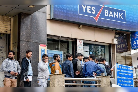 Noida: Account holders stand in a queue to withdraw money from YES Bank, at Krishna Nagar in New Delhi, Saturday, March 7, 2020. The central bank on Thursday imposed a moratorium on the capital-starved Yes Bank, capping withdrawals at Rs 50,000 per account and superseded the board of the private sector lender with immediate effect. (PTI Photo/Ravi Choudhary)(PTI07-03-2020_000036B)