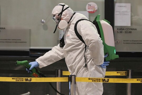 Sanitary workers disinfect the Warszawa Zachodnia (Warsaw Western) coach station at the end of the day in a new routine intended to fight the spread of the coronavirus, in Warsaw, Poland, Wednesday, March 25, 2020. For most people, the new coronavirus causes mild or moderate symptoms, such as fever and cough that clear up in two to three weeks. For some, especially older adults and people with existing health problems, it can cause more severe illness, including pneumonia and death. (AP Photo/Czarek Sokolowski)
