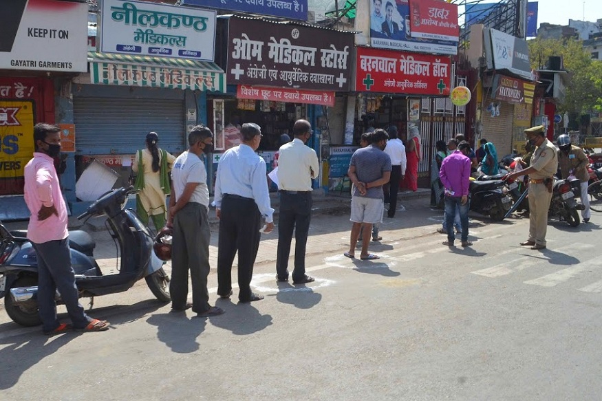 Varanasi: People maintain social distance as they stand outside a chemist shop during day-2 of a nationwide lockdown, imposed in the wake of coronavirus pandemic, in Varanasi, Thursday, March 26, 2020. (PTI Photo)(PTI26-03-2020_000098B)