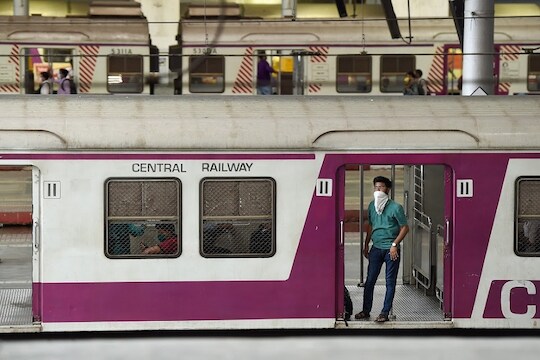 Mumbai: Passenger wearing a face mask, as a measure to prevent coronavirus spread, boards a train at CST railway station, in Mumbai, Friday, March 20, 2020. (PTI Photo/Kunal Patil)(PTI20-03-2020_000277B)