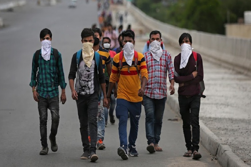 A group of Indian daily wage laborers walk along an expressway hoping to reach their homes, hundreds of kilometers away, as the city comes under lockdown in Ghaziabad, on the outskirts of New Delhi, India, Thursday, March 26, 2020. Some of India's legions of poor and people suddenly thrown out of work by a nationwide stay-at-home order began receiving aid distribution Thursday, as both the public and private sector work to blunt the impact of efforts to curb the coronavirus pandemic. Untold numbers of them are now out of work and many families have been left struggling to eat. (AP Photo/Altaf Qadri)