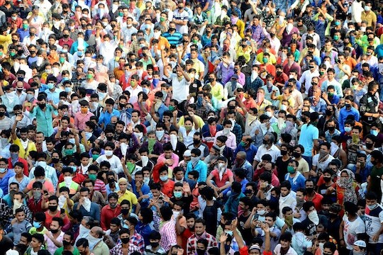 Migrant workers shout slogans during a protest against the the extension of the lockdown, at a slum in Mumbai, India, Tuesday, April 14, 2020. Indian Prime Minister Narendra Modi on Tuesday extended the world's largest coronavirus lockdown to head off the epidemic's peak, with officials racing to make up for lost time. (AP Photo/Zoya Thomas Lobo)