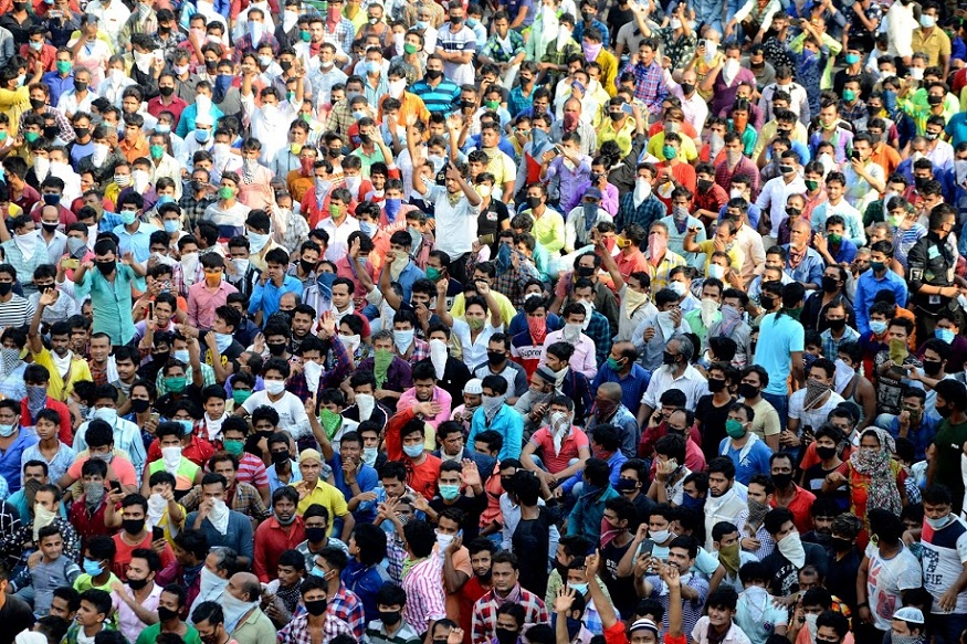 Migrant workers shout slogans during a protest against the the extension of the lockdown, at a slum in Mumbai, India, Tuesday, April 14, 2020. Indian Prime Minister Narendra Modi on Tuesday extended the world's largest coronavirus lockdown to head off the epidemic's peak, with officials racing to make up for lost time. (AP Photo/Zoya Thomas Lobo)