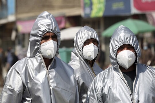 Volunteers in protective suits to help curb the spread of the coronavirus prepare to disinfect public areas in Kabul, Afghanistan, Wednesday, April 8, 2020. The new coronavirus causes mild or moderate symptoms for most people, but for some, especially older adults and people with existing health problems, it can cause more severe illness or death. (AP Photo/Rahmat Gul)