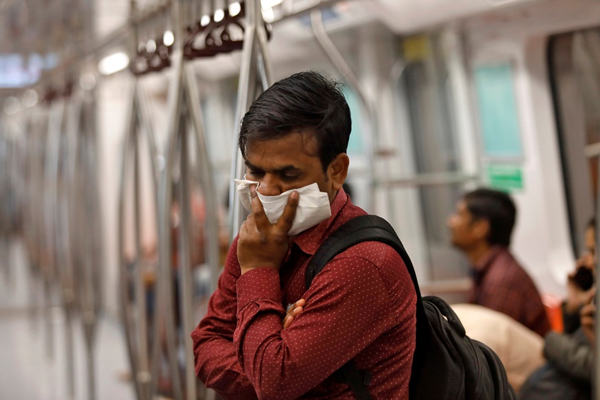 A commuter uses his handkerchief to cover his face as he travels in a metro amid coronavirus fears, in New Delhi, India, March 17, 2020. REUTERS/Anushree Fadnavis - RC2NLF918MLG