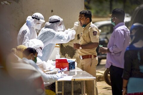 Mumbai: A medical team collects swabs from police personnel and their family members for COVID-19 tests at Yogi Nagar Police Quarters after a police inspector was found positive for the disease, in Borivali, Mumbai, Tuesday, April 7, 2020. (PTI Photo) (PTI07-04-2020_000166B)