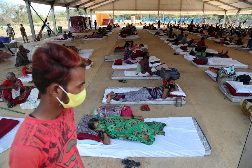 People rest at a shelter set up for migrant workers from other Indian states affected by the coronavirus lockdown in Mumbai, India, Monday, April 6, 2020. The new coronavirus causes mild or moderate symptoms for most people, but for some, especially older adults and people with existing health problems, it can cause more severe illness or death. (AP Photo/Rafiq Maqbool)