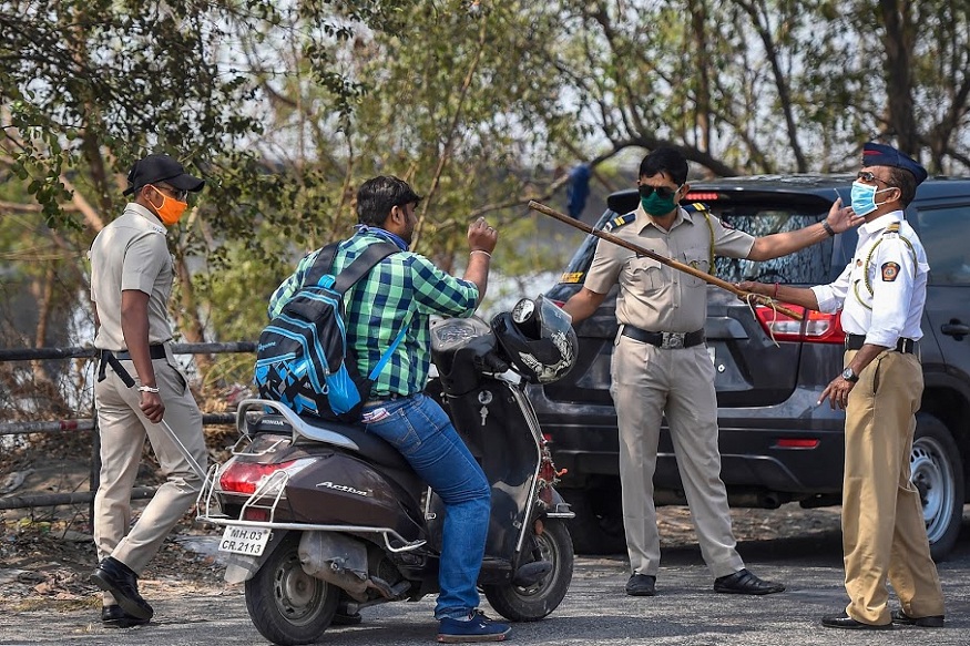 Mumbai: Police stop a scooterist while enforcing the complete lockdown imposed to contain the coronavirus pandemic, near Vashi in Mumbai, Tuesday, March 31, 2020. (PTI Photo/Kunal Patil) (PTI31-03-2020_000068B)