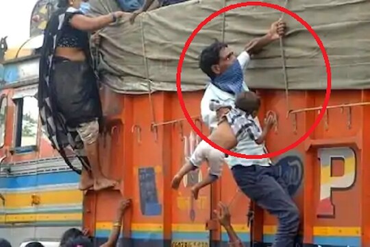 एका हातात मुलाला पकडून ट्रकवर चढतोय मजूर, व्हायरल होणाऱ्या फोटोमागची गोष्टी