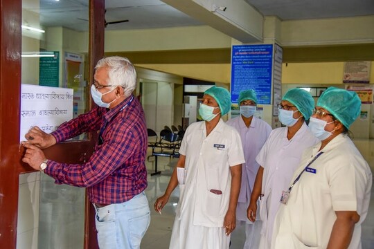 Pune: Medical staff pastes a notice on prevention against coronavirus, at the isolation ward of Naidu Hospital, in Pune, Wednesday, March 4, 2020. (PTI Photo)(PTI04-03-2020_000167B)
