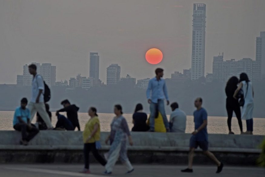 Mumbai: People enjoy a sunset at the marine drive in Mumbai on Friday. PTI Photo by Shashank Parade(PTI3_16_2018_000165B)