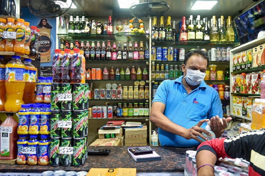 Mumbai: A shopkeeper wears a mask and sanitize his hands in the wake of deadly coronavirus, at Crawford market in Mumbai, Wednesday, March 18, 2020. (PTI Photo/Mitesh Bhuvad) (PTI18-03-2020_000222B)