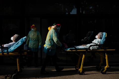 Health workers carry on a stretcher two elderly residents of a nursing home who tested positive for the new coronavirus in Barcelona, Spain, Saturday, April 11, 2020. The new coronavirus causes mild or moderate symptoms for most people, but for some, especially older adults and people with existing health problems, it can cause more severe illness or death. (AP Photo/Felipe Dana)