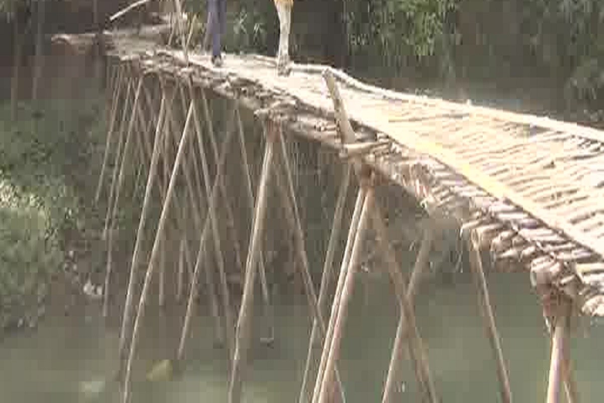 गावातील हा पूलाचा फोटो पावसाळ्यात घेण्यात आलेला आहे. लोकांना ट्यूबच्या सहाय्याने, कधी केळ्याच्या झाड्यांच्या मदतीने पावसाळ्यात भयंकर रुप धारण केलेली नदी पार करावी लागते. पूरात लोकांच्या समस्या मोठ्या प्रमाणात वाढतात. इलाजाअभावी गावातच लोकांचा मृत्यू होतो. पावसाळ्यात चार महिने या लोकांचा इतर गावांशी संपर्क तुटतो. नदीत पूराचं पाणी कमी झाल्यानंतर ग्रामस्थ एकमेकांच्या सहाय्याने नदीवर अशाप्रकारे पूल बांधतात. त्यानंतर आठ महिने लोक या पूलाच्या मदतीने, जीव धोक्यात घालून प्रवास करतात. गावातील हा पूलाचा फोटो पावसाळ्यात घेण्यात आलेला आहे. लोकांना ट्यूबच्या सहाय्याने, कधी केळ्याच्या झाड्यांच्या मदतीने पावसाळ्यात भयंकर रुप धारण केलेली नदी पार करावी लागते. पूरात लोकांच्या समस्या मोठ्या प्रमाणात वाढतात. इलाजाअभावी गावातच लोकांचा मृत्यू होतो. पावसाळ्यात चार महिने या लोकांचा इतर गावांशी संपर्क तुटतो. नदीत पूराचं पाणी कमी झाल्यानंतर ग्रामस्थ एकमेकांच्या सहाय्याने नदीवर अशाप्रकारे पूल बांधतात. त्यानंतर आठ महिने लोक या पूलाच्या मदतीने, जीव धोक्यात घालून प्रवास करतात.