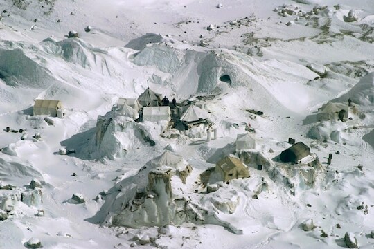 FILE - This Feb. 1, 2005 file photo shows an aerial view of an Indian army camp at Siachen Glacier, about 750 kilometers (469 miles) northwest of Jammu, India.  Siachen Glacier, a 6,100-meter (20,000-foot) icy Himalayan expanse makes up the world's highest battlefield. Thousands of troops have been deployed on the glacier since 1983, laying claim to territory so hostile to human life it has never even been demarcated. Far more troops have died from avalanches or bitter cold than in combat. While there are no clear borders on the glacier, its position between the Indian and Pakistani-controlled portions of Kashmir make it a key part of any final map that may be drawn of the region. Its high altitude gives its occupants an advantage over those below. (AP Photo/Channi Anand, File)