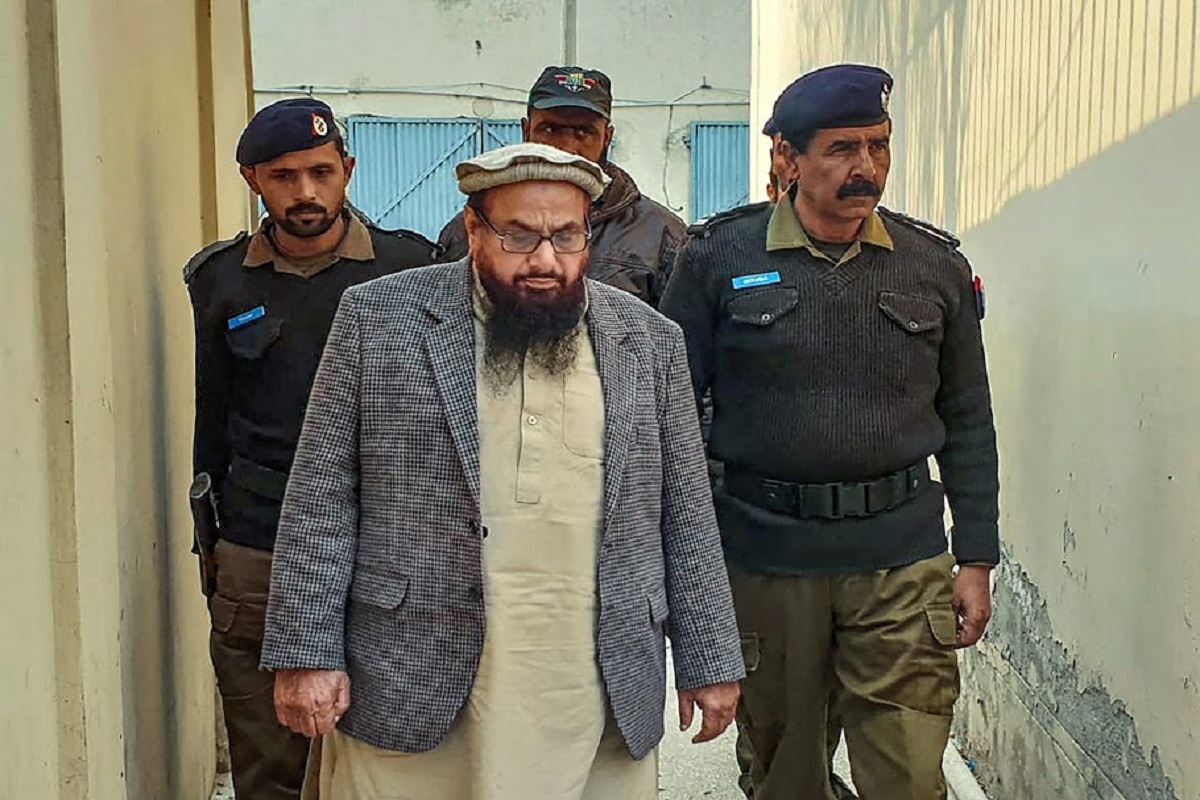 **EDS: FILE PICTURE** New Delhi: In this Friday, Dec. 20, 2019 file picture JuD chief Hafiz Saeed is produced at a court in Lahore. An anti-terrorism court in Pakistan, Wednesday, Feb. 12, 2020, sentenced the Mumbai attack mastermind Saeed to 11 years in jail in a terror financing case. (PTI Photo) (PTI2_12_2020_000099B)