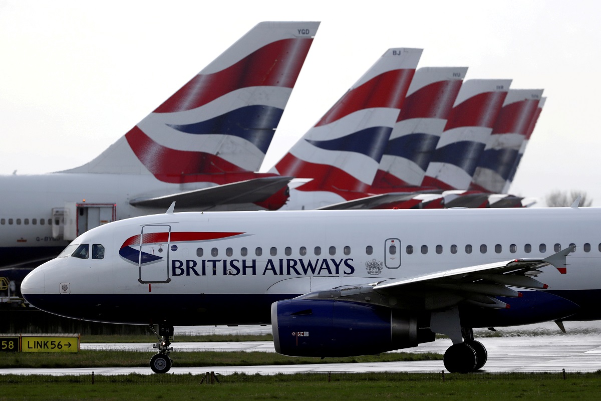 FILE PHOTO: A British Airways plane taxis past tail fins of parked aircraft near Terminal 5 at Heathrow Airport in London, Britain, March 14, 2020. REUTERS/Simon Dawson/File Photo