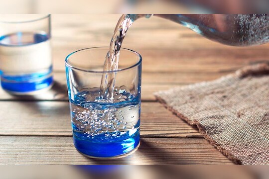 Glasses of water on a wooden table. Water was poured into the beaker. Selective focus. Shallow DOF