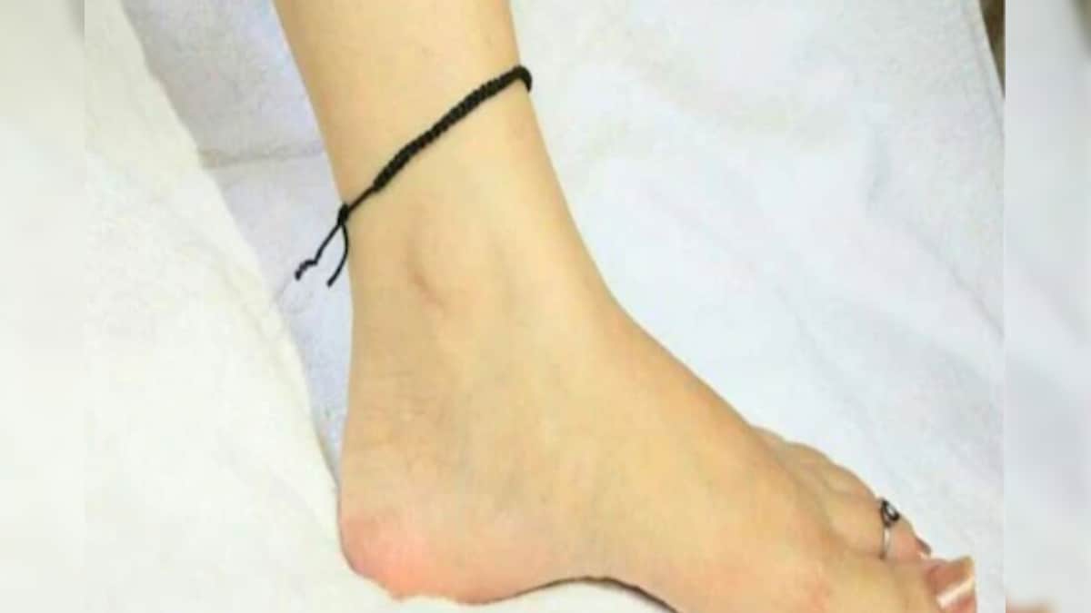 Why is the black thread tied on the feet? What is the religious