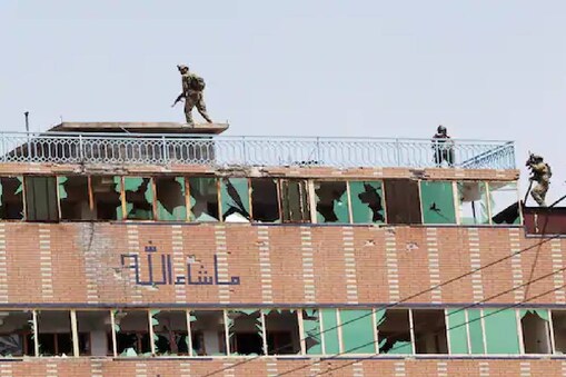 Afghan security forces take position on a building where the attackers were hiding after an attack on a jail compound in Jalalabad, Afghanistan, on Monday. (Reuters)
