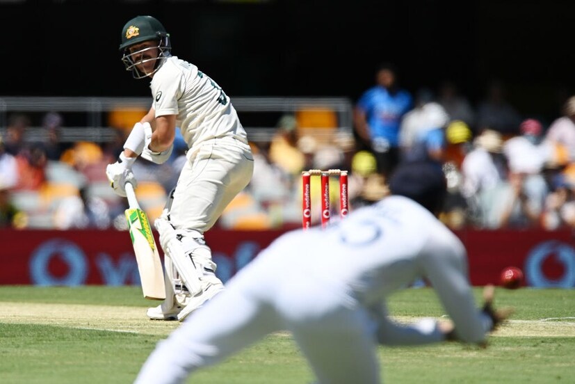 David Warner looks on as Rohit Sharma takes a catch. 