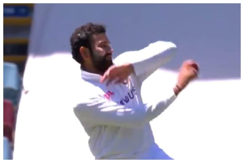 Rohit Sharma takes the ball after Navdeep Saini was forced off the field with an injury. 