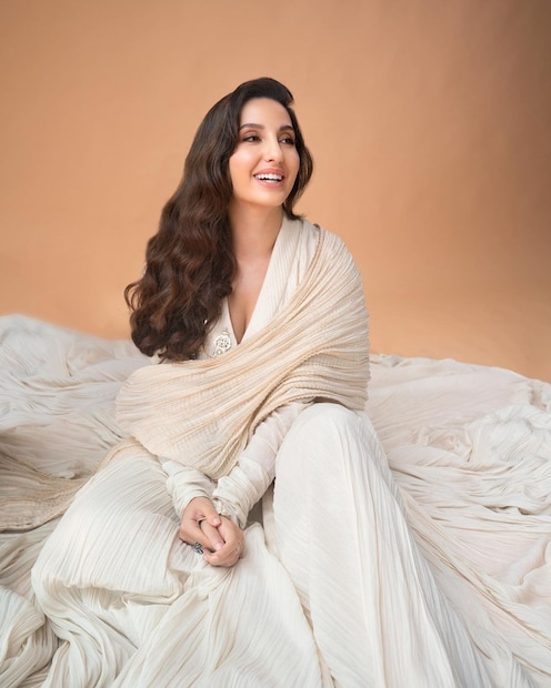 Nora Fatehi is a pocture of elegance in an off-white traditional suit. 