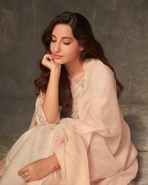 Nora Fatehi sits pretty in the floral suit. 