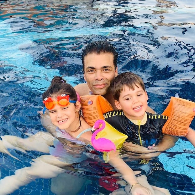 Karan Johar has a gala time with his twins Roohi and Yash. 