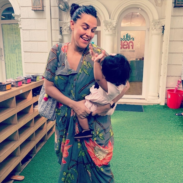 Neha Dhupia caugth unawares with daughter Mehr. 