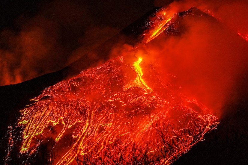 Large streams of red hot lava flow as Mount Etna, Europe's most active volcano, continues to erupt, as seen from the village of Fornazzo, Italy on February 23, 2021. (Image: REUTERS/Antonio Parrinello)