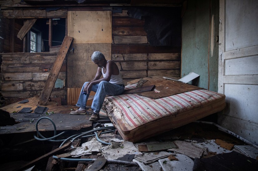 A 70-year-old man sits inside his house which was heavily damaged by Hurricane Ida in Houma, Louisiana, U.S., on August 30. (Image: REUTERS/Adrees Latif)