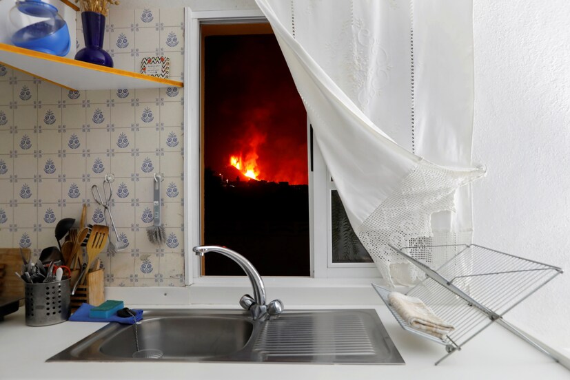 Lava is seen through the window of a kitchen from El Paso following the eruption of a volcano on the Canary Island of La Palma, Spain, on September 28. (Image: REUTERS/Jon Nazca)