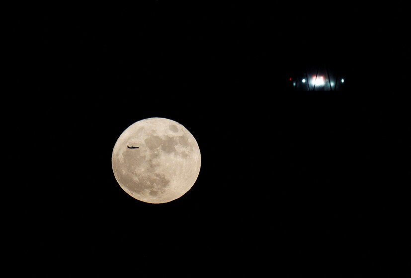 SPAIN: Full moon seen behind a lighthouse in Arinaga, on the island of Gran Canaria, Spain. This celestial phenomenon causes the moon to appear bigger and brighter than usual. (Image: Reuters) 