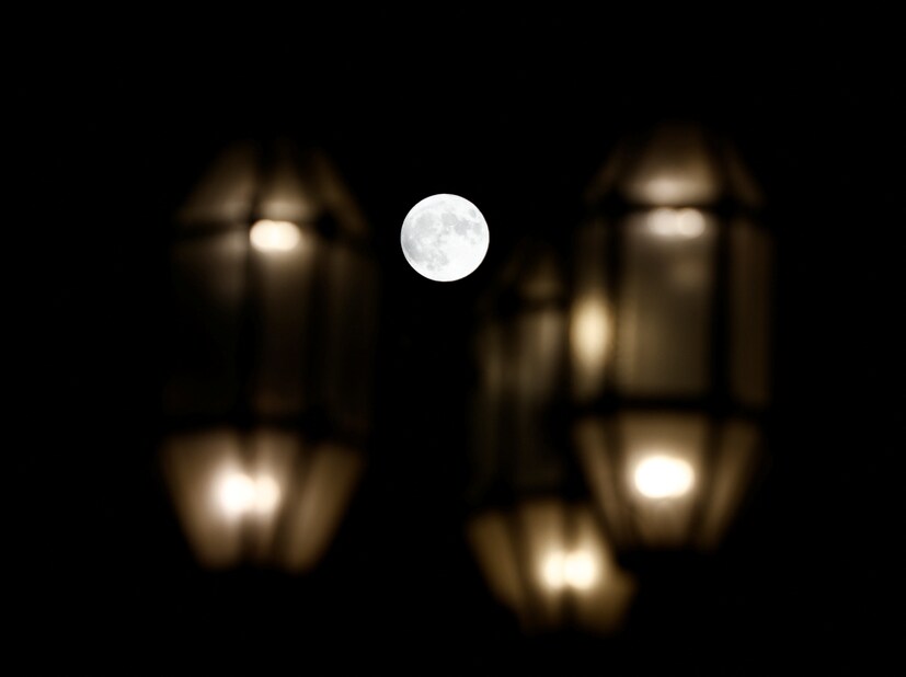 MALTA: A full moon is seen behind street lights in Valletta, Malta. (Image: Reuters) 