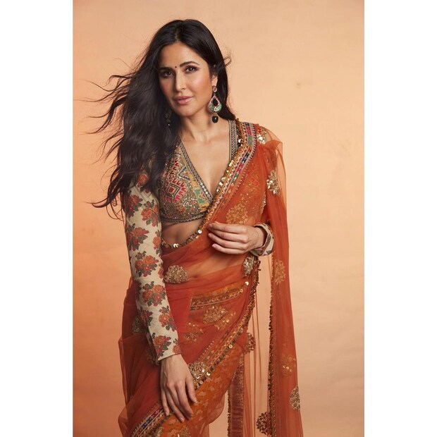 Donning this rusted red Sabyasachi saree, Katrina showed us how desi could be glamorous as well. The actress paired the net saree with a full-sleeved blouse with a plunging neckline. (Image: Instagram)