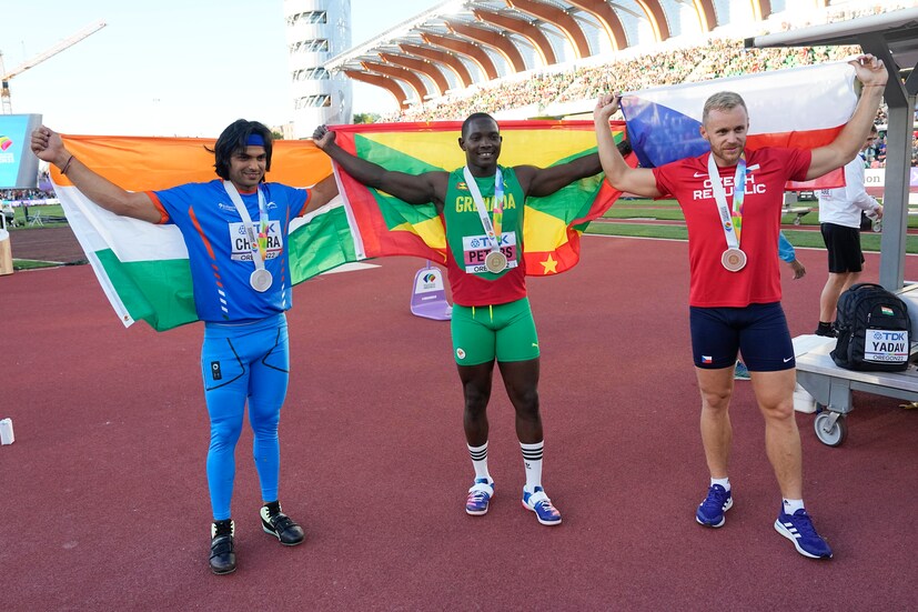 India’s Neeraj Chopra wins silver, poses with gold medallist Anderson Peters (center) and bronze medalist Jakub Vadlejch of the Czech Republic in the men's javelin throw final at the World Athletics Championships on Saturday (AP Photo)