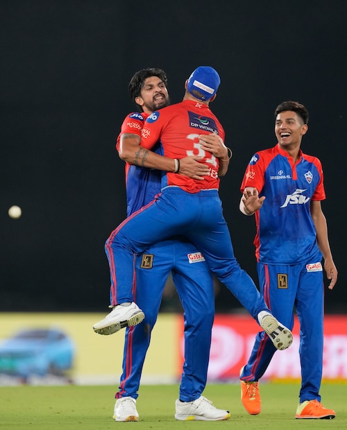Delhi Capitals' Ishant Sharma, left, hugs captain David Warner to celebrate their win in the Indian Premier League cricket match against Gujarat Titans in Ahmedabad, India, Tuesday, May 2, 2023. (AP Photo)