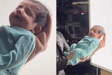  12 ദിവസം പ്രായമുള്ള കുഞ്ഞിന്‍റെ പാസ്പോര്‍ട്ട് ചിത്രമെടുക്കാന്‍ പാടുപെട്ട് ഒരച്ഛൻ