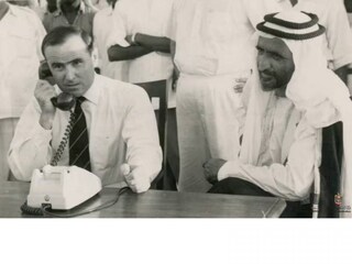 Watched by Sheikh Rashid, the British political resident Donald Hawley opens Dubai's telephone service on July 29, 1960. Photo: Lady Ruth Hawley
