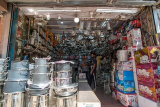 Customers at Utensils shop at wholesale market of stainless steel utensil at a Sadar Bazar ahead of Diwali, Old Delhi is known for its bustling wholesale market. Copyright (c) 2021 PradeepGaurs/Shutterstock.