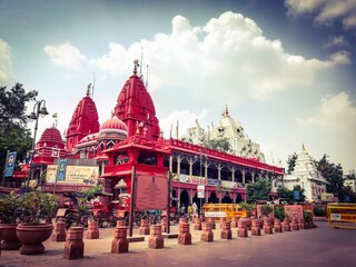 Red Jain Temple and white Gauri Shankar Hindu Temple at Chandni chowk, Delhi India. Copyright (c) 2023 Azhar_khan/Shutterstock.