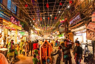 People in Urdu Bazar or market street of historical part of Chandni Chowk locality of Old Delhi in the evening. Copyright (c) 2019 Amit kg/Shutterstock.