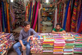 Shopkeeper waiting for customers at Gandhi Nagar Market, Asia biggest readymade garments and textile market  in New Delhi, India.. Gandhi nagar has many shops and factories. Copyright (c) 2021 PradeepGaurs/Shutterstock.