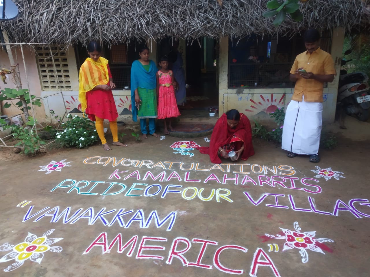  ଗାଁର ଲୋକେ ନିଜ ନିଜ ଘର ବାହାରେ ରଙ୍ଗୋଲି ବନାଇ କମଳାଙ୍କ ପାଇଁ ଅଭିନନ୍ଦନର ବାର୍ତ୍ତା ବି ଲେଖିଛନ୍ତି । ରଙ୍ଗୋଲିରେ ସେମାନେ ଲେଖିଛନ୍ତି, ‘‘ଶୁଭେଚ୍ଛା, କମଳା ହାରିସ୍! ତୁମ ପାଇଁ ଆମ ଗାଁ ଗର୍ବିତ । ଓଣକ୍କମ୍ ଆମେରିକା!’’ (ଫଟୋ: News18)