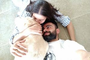 An Adorabe Picture of Virat & Anushka Cuddle Up With Their Furry Friend