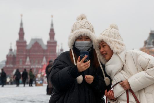 File photo: Young women are pictured wearing a medical mask in Red Square in Moscow, Russia. (Reuters) File photo: Young women are pictured wearing a medical mask in Red Square in Moscow, Russia. (Reuters)