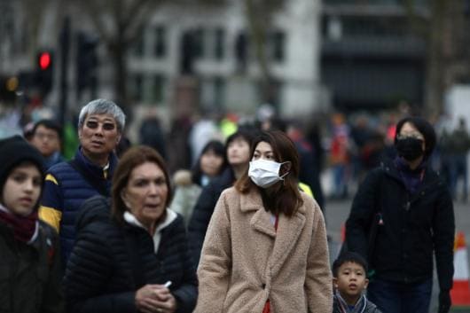 People wearing face masks are pictured in London, Britain.