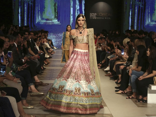 Models present creations of designers Shazia and Sehr during the Bridal Fashion Week organized by the Pakistan Fashion Design Council, in Lahore, Pakistan. Photo: AP Models present creations of designers Shazia and Sehr during the Bridal Fashion Week organized by the Pakistan Fashion Design Council, in Lahore, Pakistan. Photo: AP